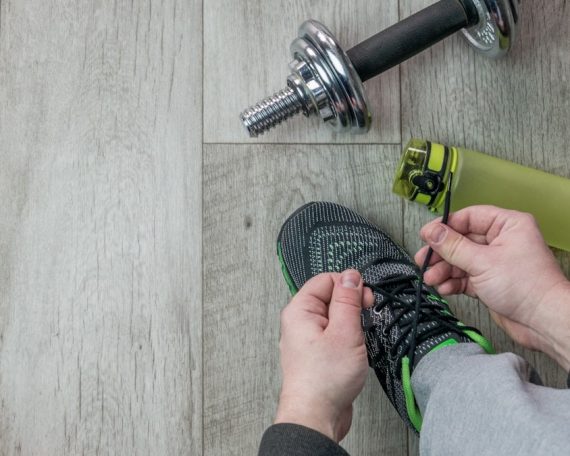 Fitness objects isolated on wooden background. Gray Sneakers, dumbbells and water bottle. Active, healthy lifestyle, sport, fitness, and objects concept. More of my photos and videos Adobe Stock:http://bit.ly/3RqlciK More of my photos and videos Shutterstock: https://www.shutterstock.com/g/ALEKSANDRBERDYUGIN My email: bermix999@gmail.com
