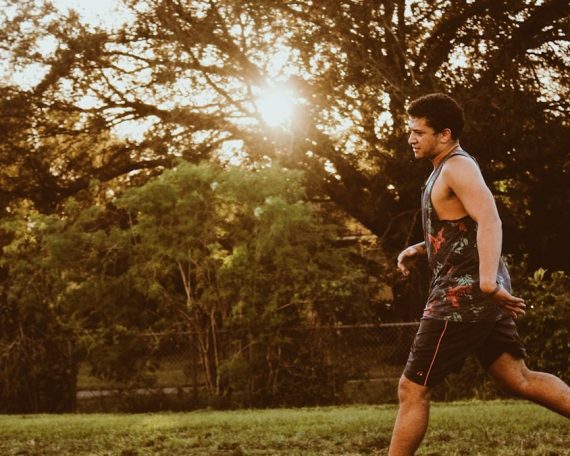 man playing soccer during daytime